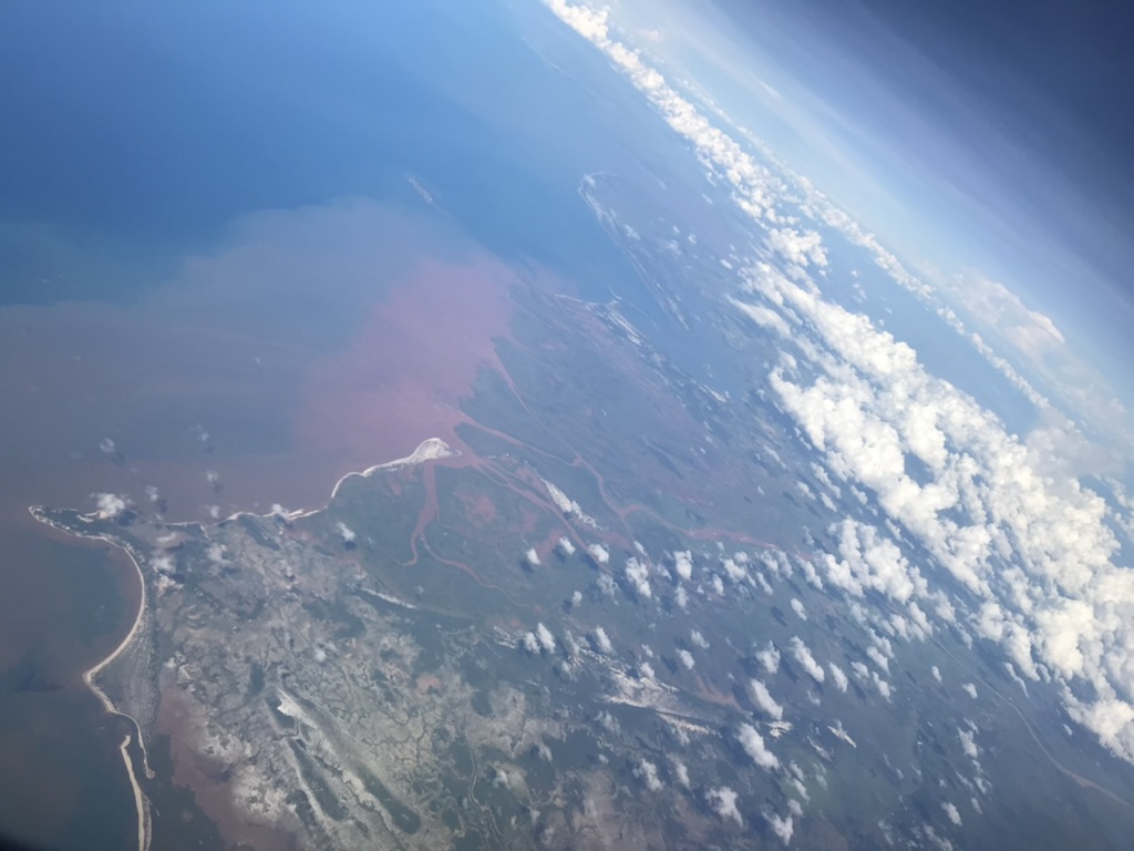 a river delta showing the red earth emptying into the ocean